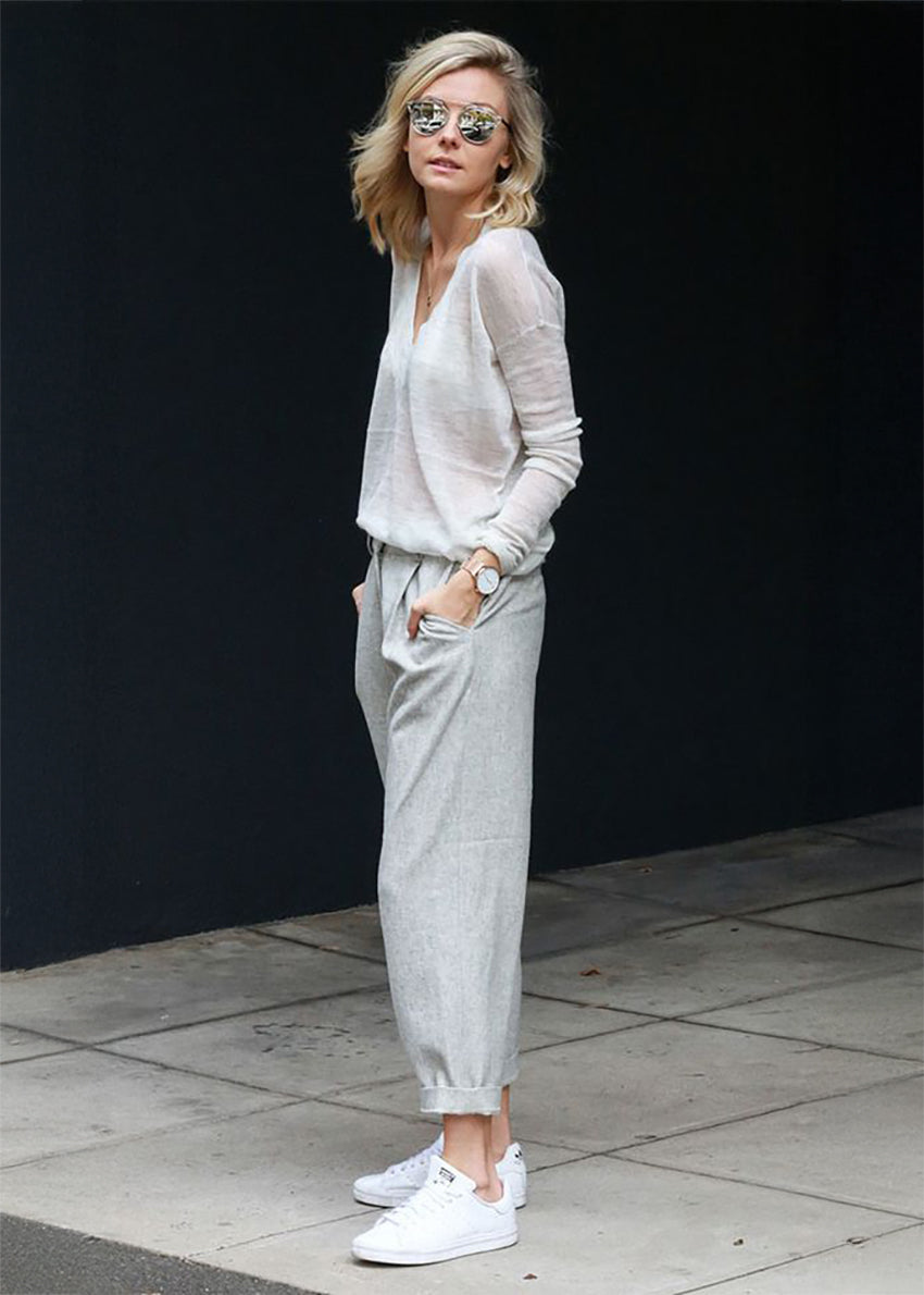 The sweater showcases a deep V-neckline at the front and back, adding a touch of sophistication to its minimalistic design.