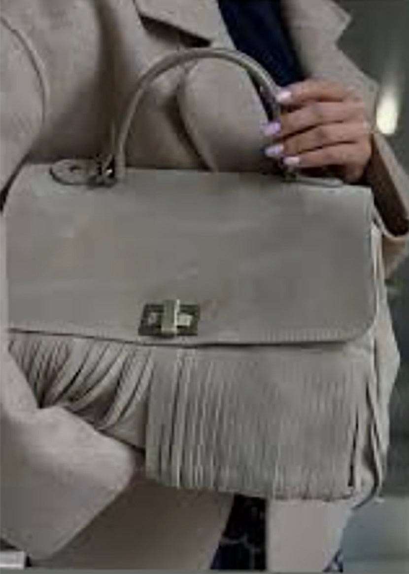 A brown suede handbag with a cascade of leather fringes in the central part, positioned against a white background.