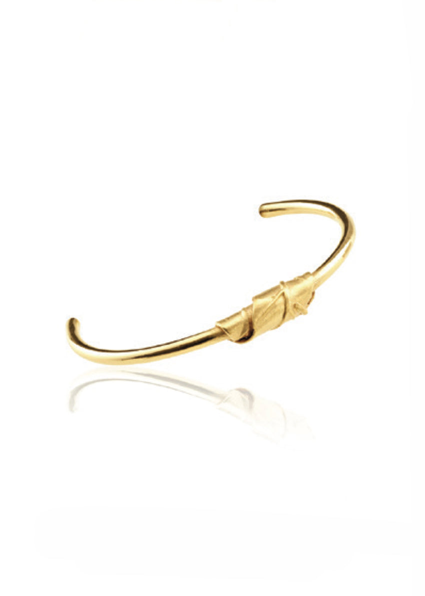 Gold bracelet on a white background