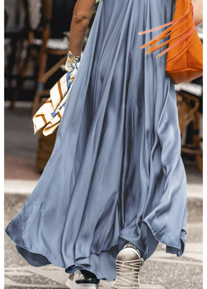 Woman wearing a silk dress with a orange bag