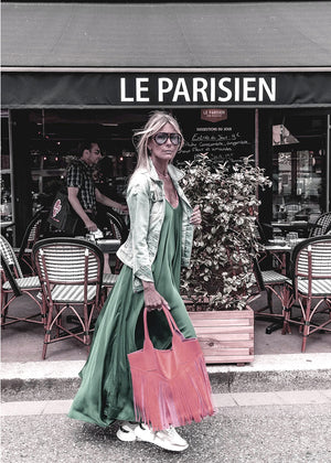 Woman walking on a street in a silk long dress