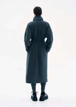 A model wearing a gray coat with a belt, featuring a buttoned front and a flowing fit.