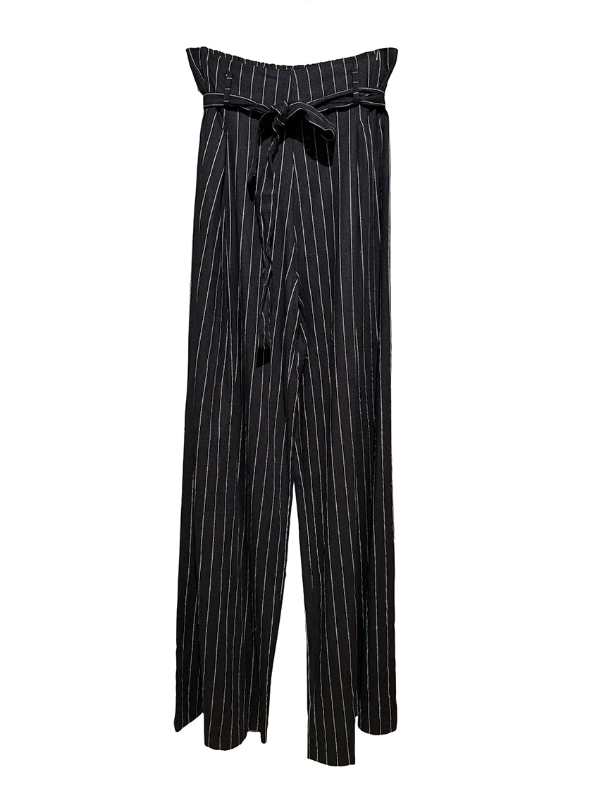 Close-up of black pants with vertical stripes and a tie-waist detail.