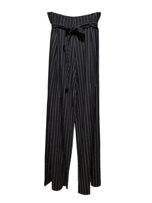 A pair of black and white striped pants with a tie-waist detail.