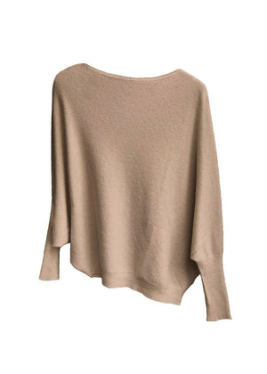 A tan, asymmetrical hemline sweater with fitted sleeves that flare out into a poncho-like shape