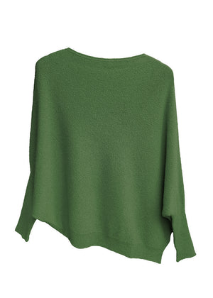 A green, asymmetrical hemline sweater with fitted sleeves that flare out into a poncho-like shape