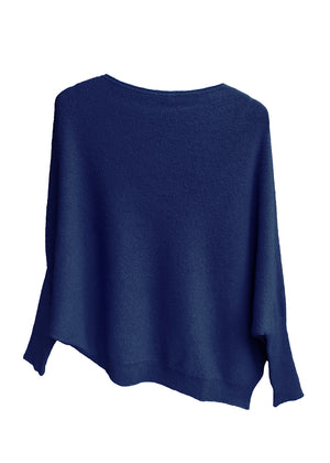 A midnight blue, asymmetrical hemline sweater with fitted sleeves that flare out into a poncho-like shape