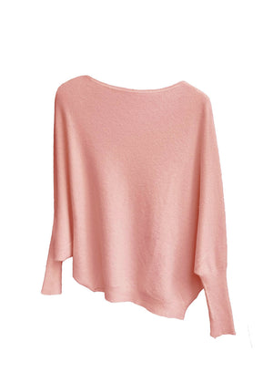 A salmon, asymmetrical hemline sweater with fitted sleeves that flare out into a poncho-like shape
