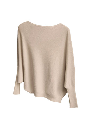 A wheat, asymmetrical hemline sweater with fitted sleeves that flare out into a poncho-like shape