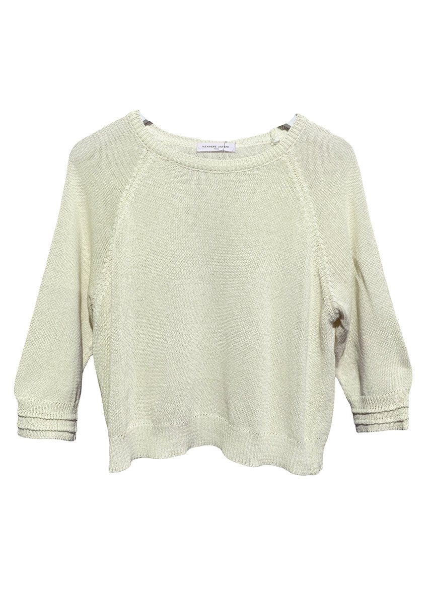Cornsilk short sweater with 3/4 sleeves and decorative stitching on the sleeves laid flat.