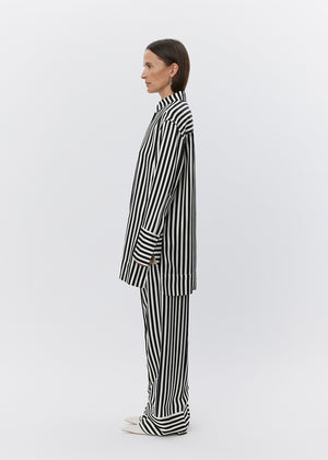 Woman wearing a black and white striped outfit on a white background