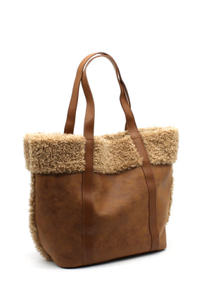 A peru suede tote bag with faux shearling trim, sturdy handles, and a spacious design.