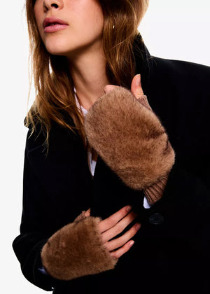 Person wearing brown fur-lined gloves with a plain background