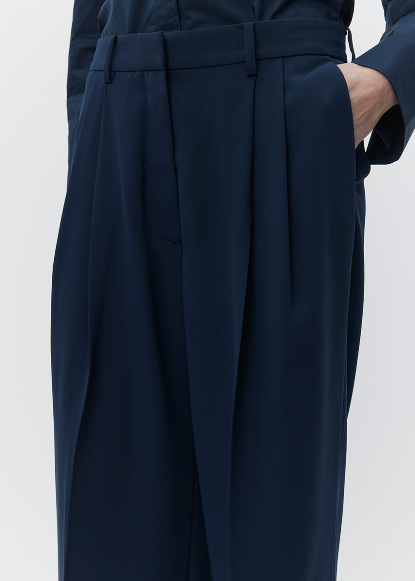 Navy blue pants with a belt on a white background