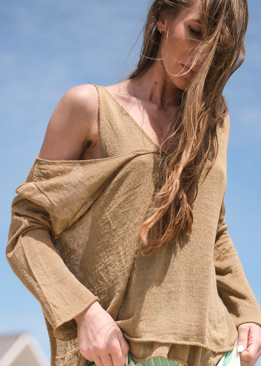 Beige long-sleeve top with 'Rogue' label on a white background