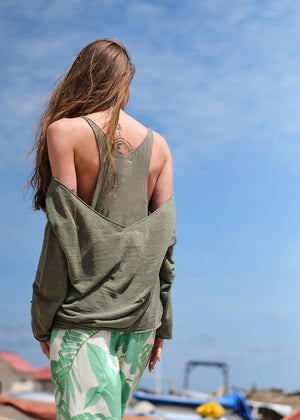 This stylishly funky yet timeless pullover features a medium length, deep V neckline on both sides, wide and relaxed fit, and long sleeves.