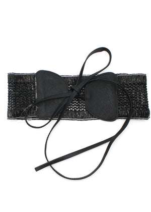 A handcrafted woven waist belt with a bow accent, featuring a soft black tone and an adjustable tie closure.