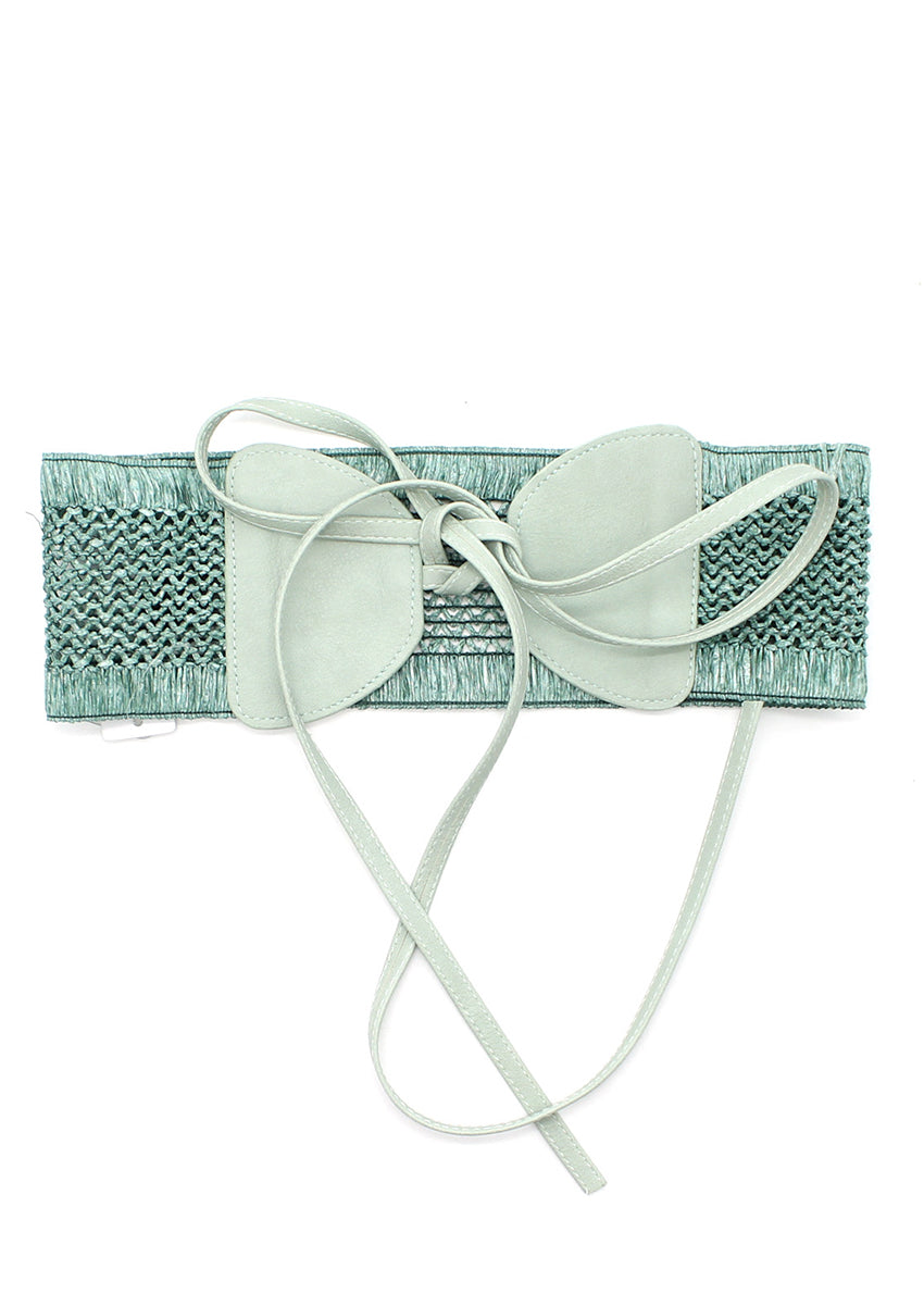 A handcrafted woven waist belt with a bow accent, featuring a soft mint-green tone and an adjustable tie closure.