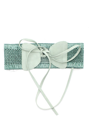 A handcrafted woven waist belt with a bow accent, featuring a soft mint-green tone and an adjustable tie closure.