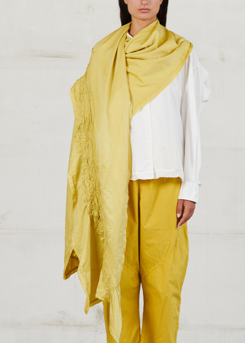 Unisex yellow scarf with decorative stitching, made of soft cotton voile fabric, with frayed edges.