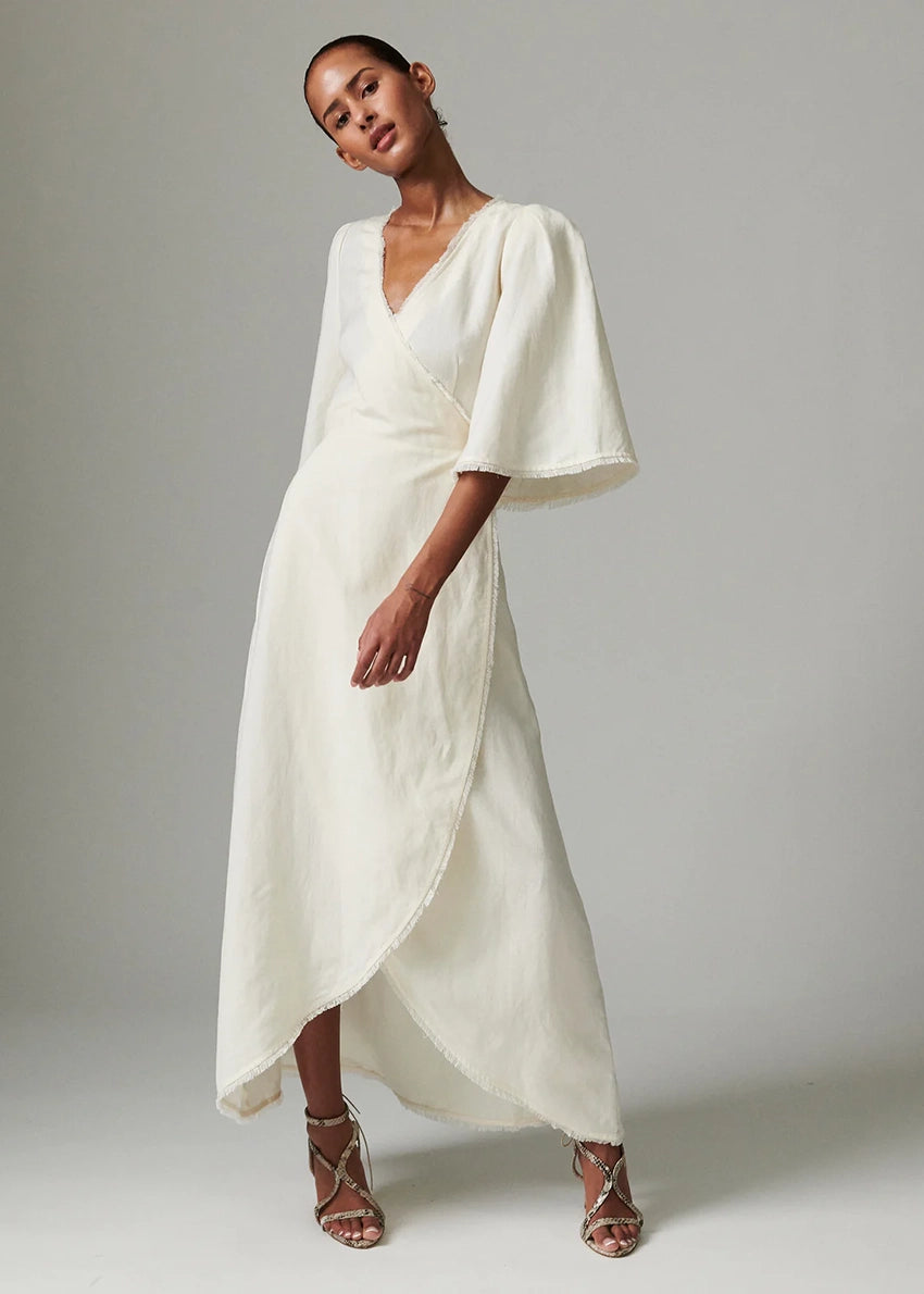Woman wearing a white dress with a plain background