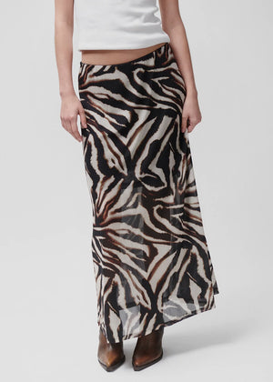 Person wearing a zebra print skirt on a white background