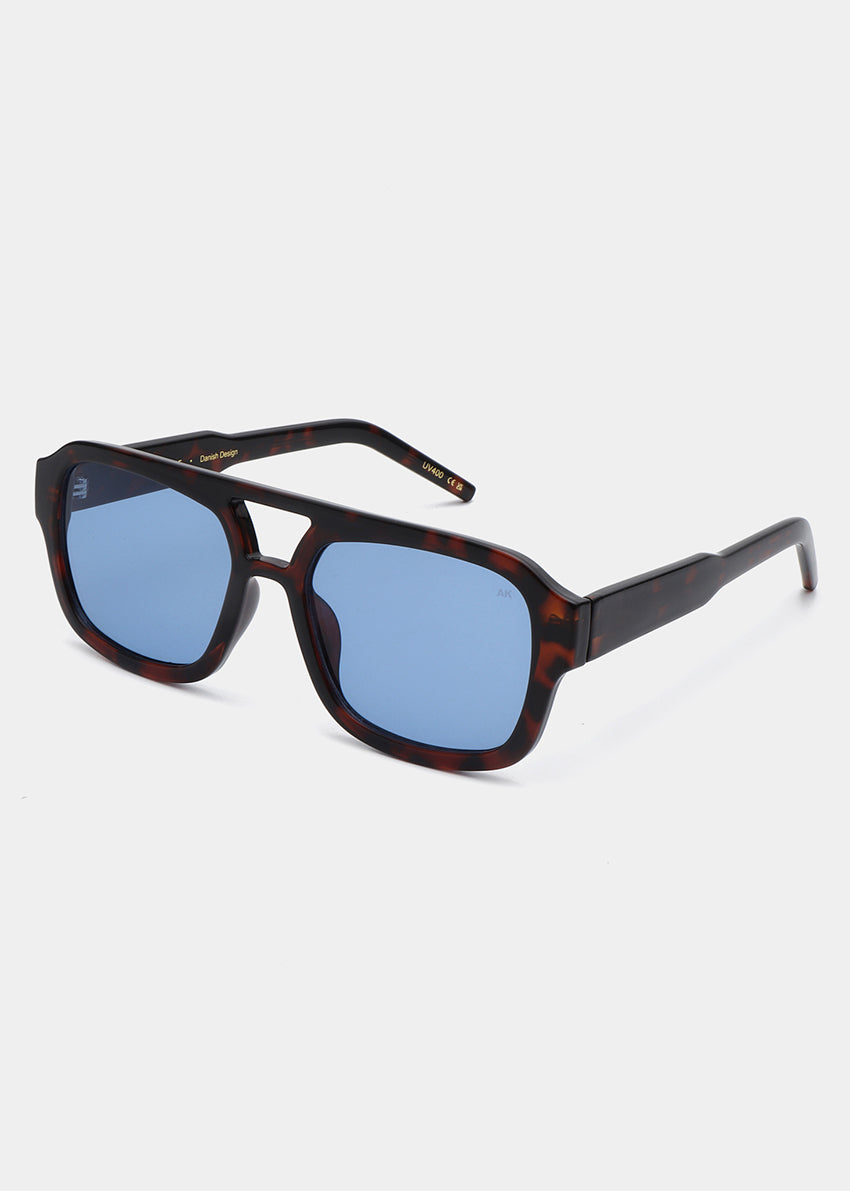Sunglasses with blue lenses and tortoiseshell frame on a white background