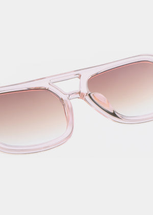 Pink sunglasses with gradient lenses on a light pink background