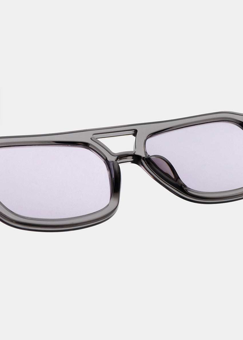 Sunglasses with a gray frame and clear lenses on a white background