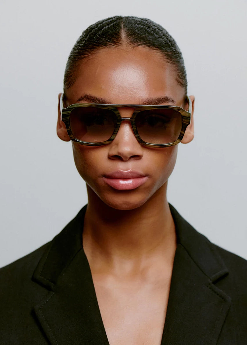 Sunglasses with tortoiseshell frame and gradient lenses on a white background