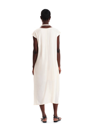 Person wearing a white sleeveless dress on a white background