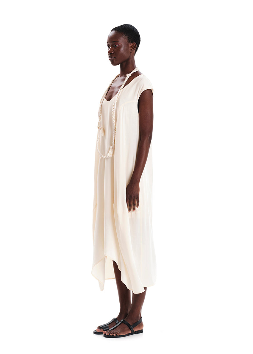 Woman wearing a white sleeveless dress on a white background