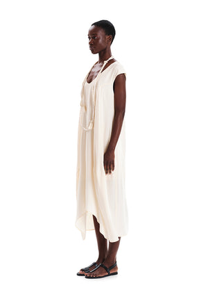 Woman wearing a white sleeveless dress on a white background