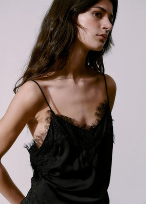Person wearing a black top with lace details