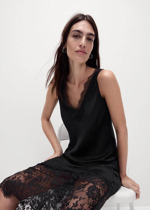 Discover timeless elegance with our Black Viscose Satin Full-Length Dress. Crafted from a lightweight satin weave, features a flattering V-neckline and delicate lace trim with scallop edges. The lace panel at the hem and scallop hemline , perfect for any occasion. With a convenient pull-on style