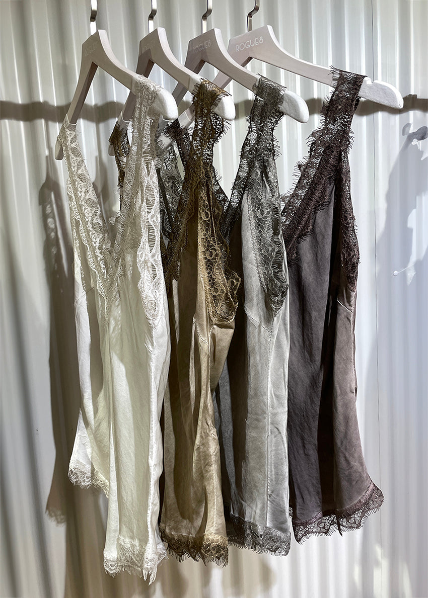 Four tank top with lace details hanging on.