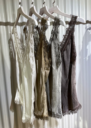 Four tank top with lace details hanging on.