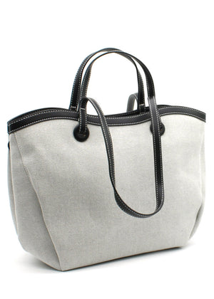A black Lamorinda bag with brown leather-like details and a zipper closure.