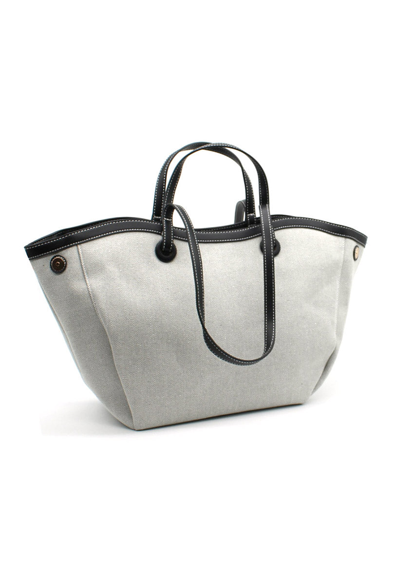 A beige Lamorinda bag with black leather-like details and a zipper closure.
