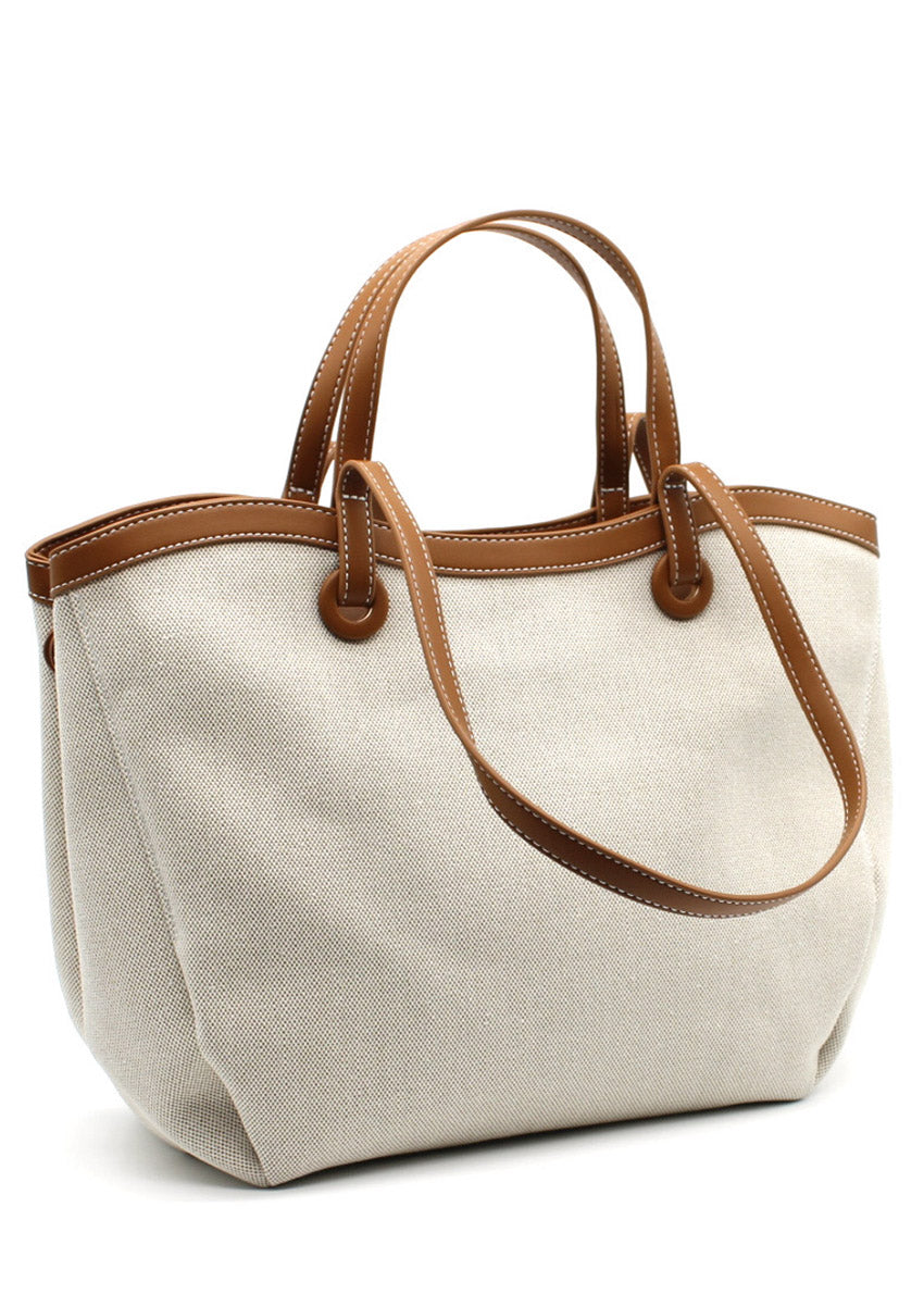 A beige Lamorinda bag with brown leather-like details and a zipper closure.