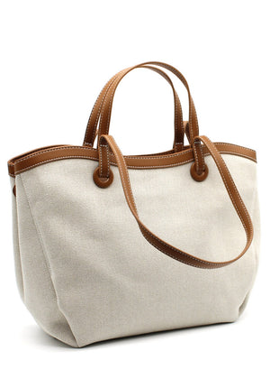 A beige Lamorinda bag with brown leather-like details and a zipper closure.