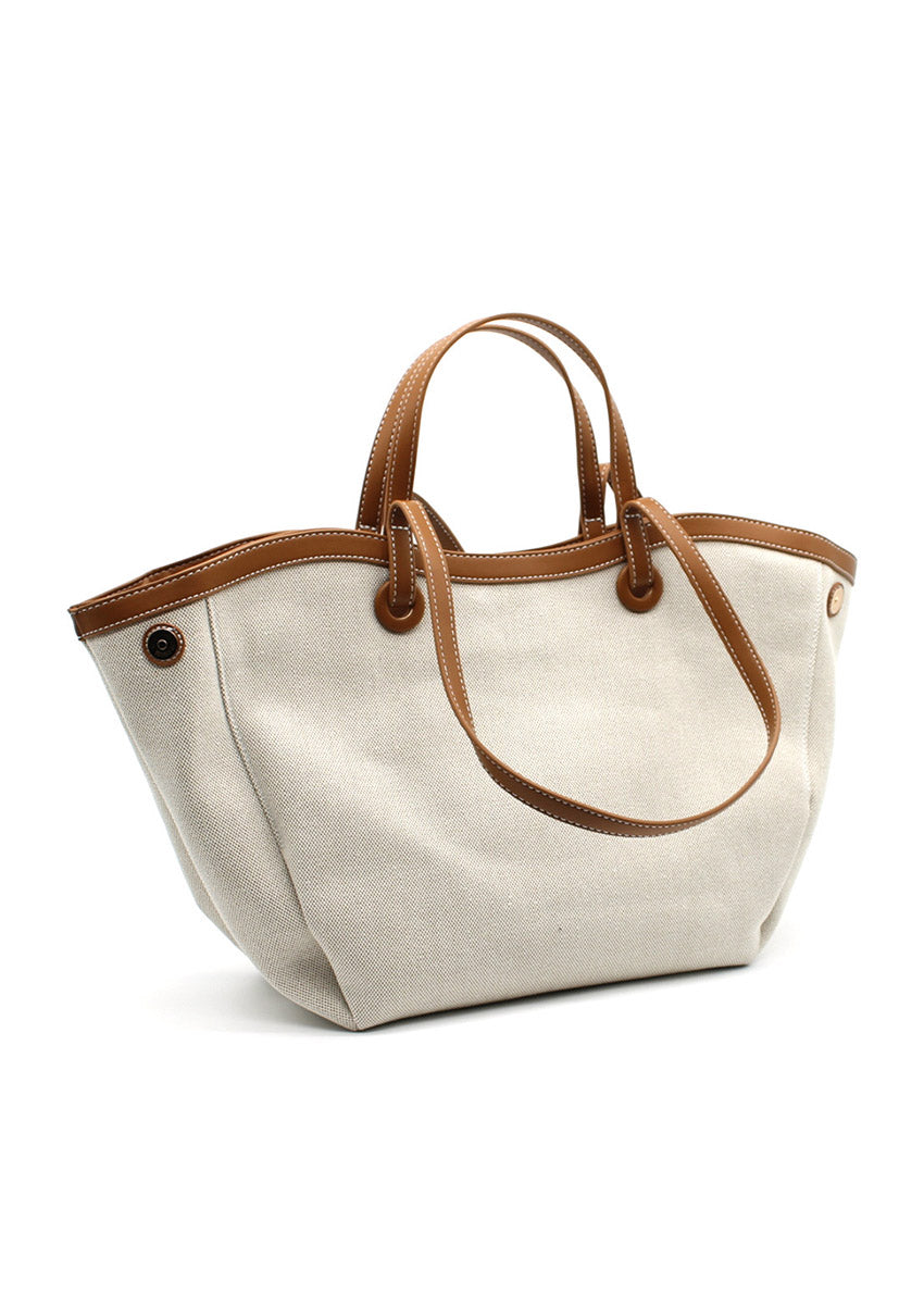 A beige Lamorinda bag with brown leather-like details and a zipper closure.