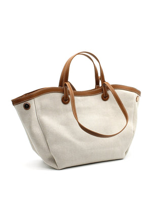 A beige Lamorinda bag with brown leather-like details and a zipper closure.