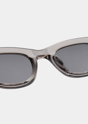 Sunglasses with a transparent frame and dark lenses on a white background