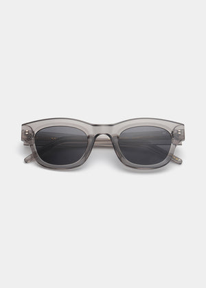 Sunglasses with a transparent frame and dark lenses on a white background