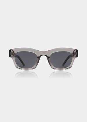 Sunglasses with a transparent frame and dark lenses on a white background
