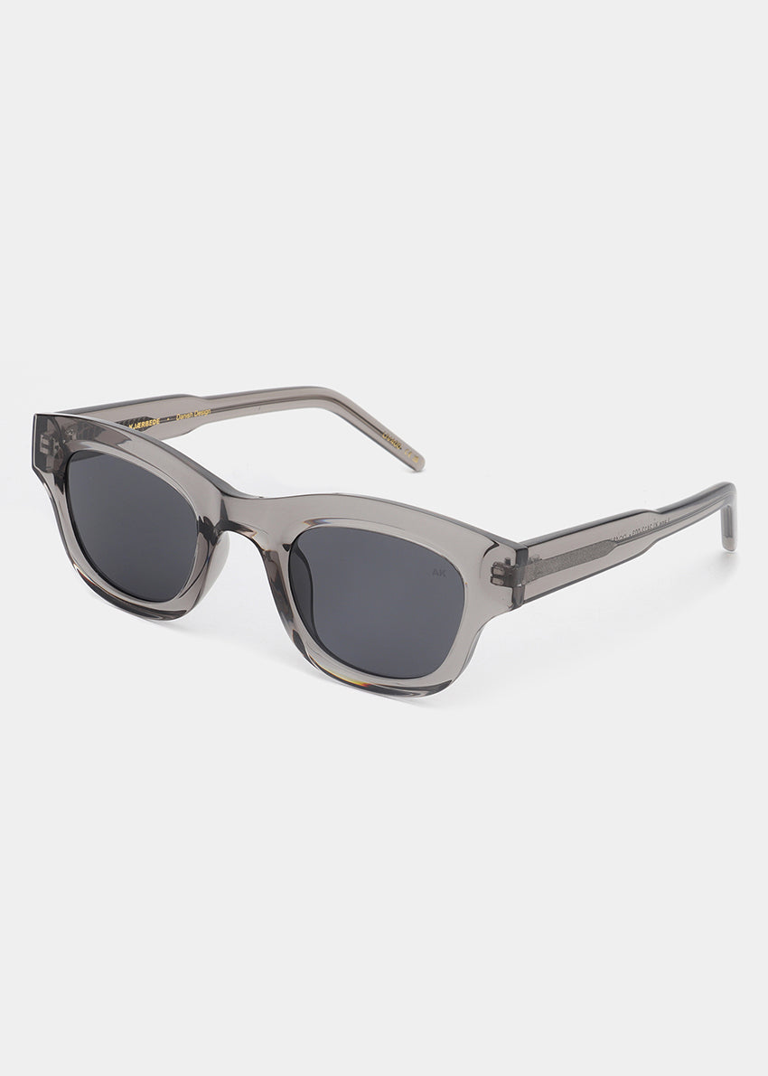 Sunglasses with a transparent frame and dark lenses on a white background