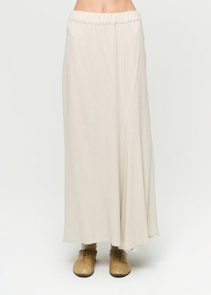 Beige skirt worn by a person on a white background
