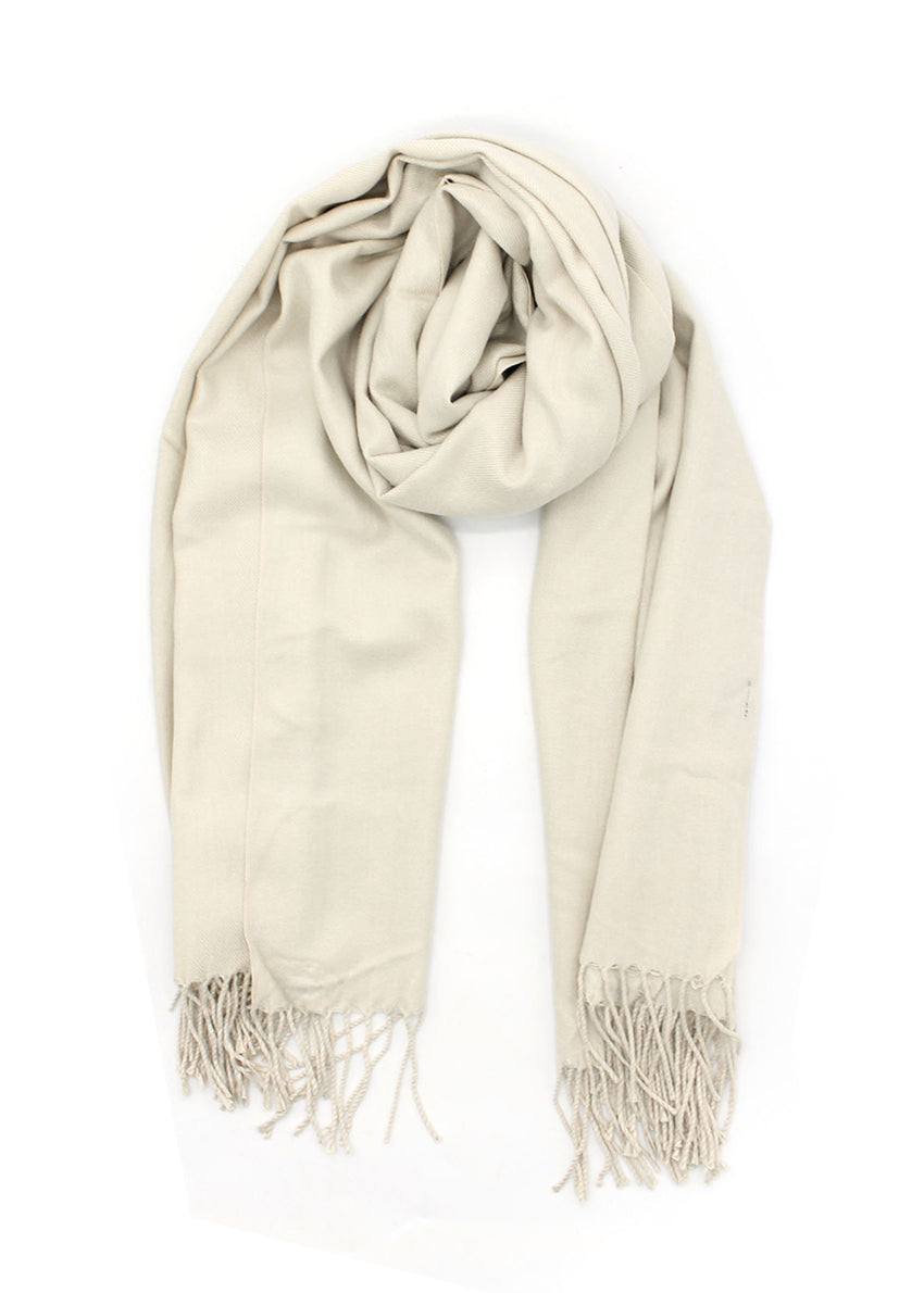 Beige shawl with fringed details on a white background