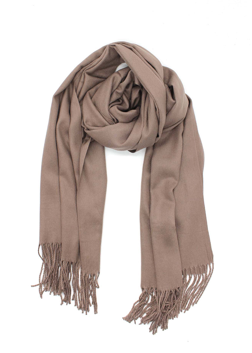 Tan shawl with fringed details on a white background